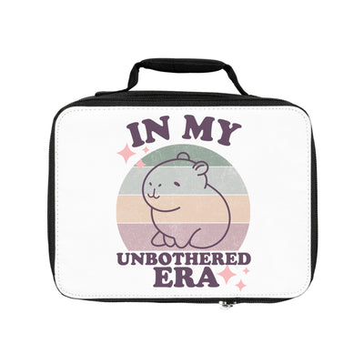 Personalized kids lunchbox with "In My Unbothered Era" text and a cute capybara design on a sunset-colored background.