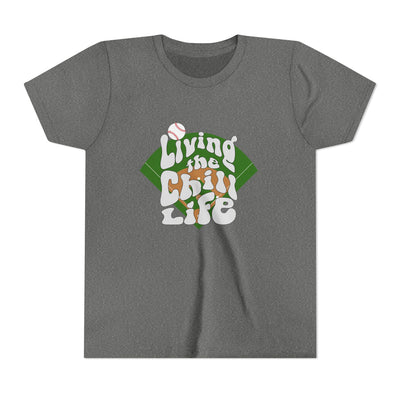 Unisex youth t-shirt with "Living the Chill Life" text and baseball diamond graphic in green, white, and orange colors.