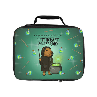 Capybara character in wizard's robe holding potion bottle, with text "Capybara School of Witchcraft & Wizardry" on a green lunchbox.