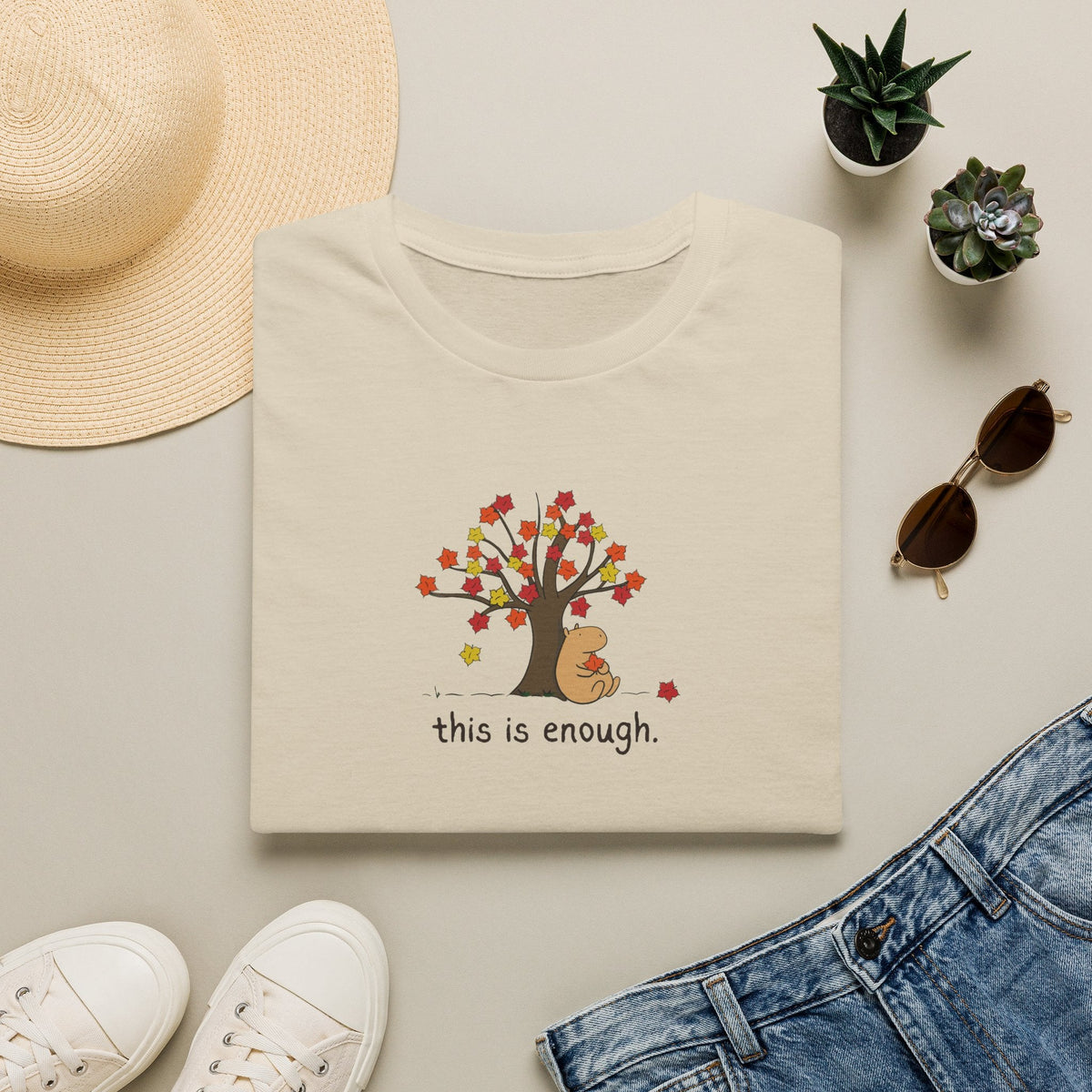 Capy Life softstyle t-shirt in beige featuring a capybara under an autumn tree with the text this is enough
