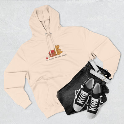 Capy Life beige fleece hoodie featuring a hand-drawn capybara eating a cider donut next to a basket of red apples