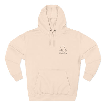 Capy Life beige unisex hoodie featuring a small minimalist embroidered capybara and the text I'll catch up on the chest.