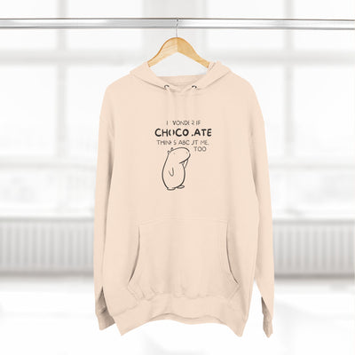 Capy Life premium beige hoodie featuring Gene the Capybara line art and the text I Wonder If Chocolate Thinks About Me Too