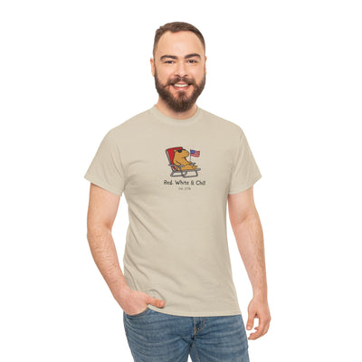 A man wearing a Capy Life beige t-shirt with a funny capybara graphic lounging in a chair with an American flag.