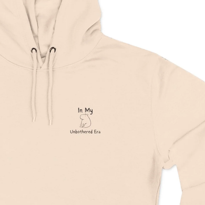 Capy Life cream-colored premium fleece hoodie with a small, minimalist embroidered capybara and text on the chest.