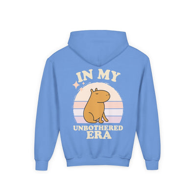 Capy Life blue hoodie featuring a retro sunset graphic with a capybara and the text In My Unbothered Era on the back.