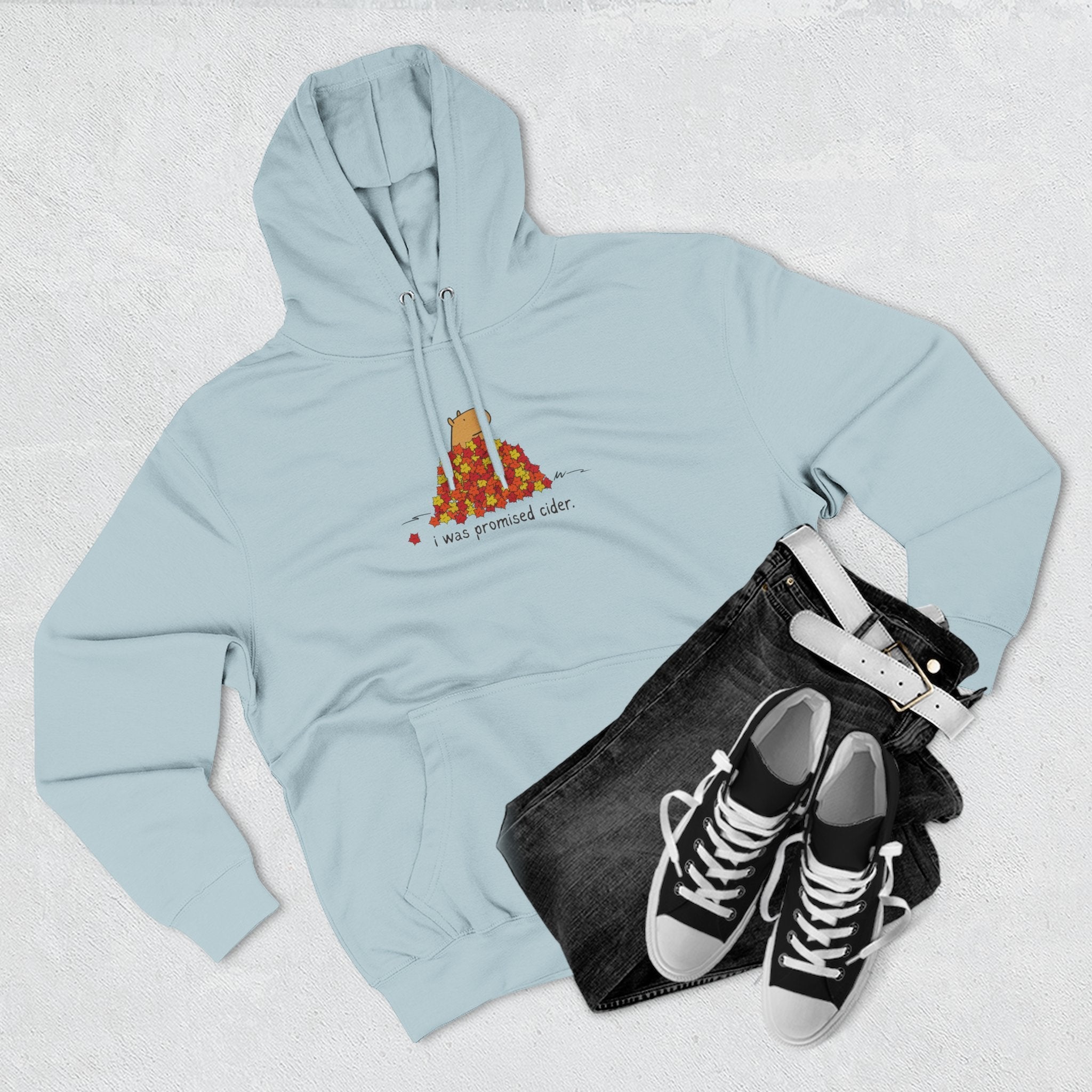 Capy Life light blue fleece hoodie featuring a capybara in autumn leaves with the text I was promised cider