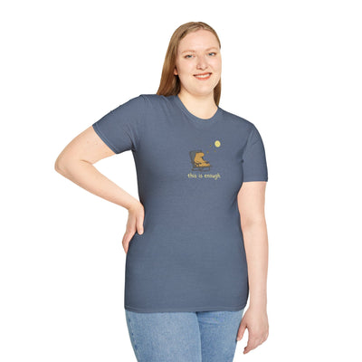 A woman wearing a Capy Life softstyle t-shirt in slate blue featuring a capybara relaxing under the moon.