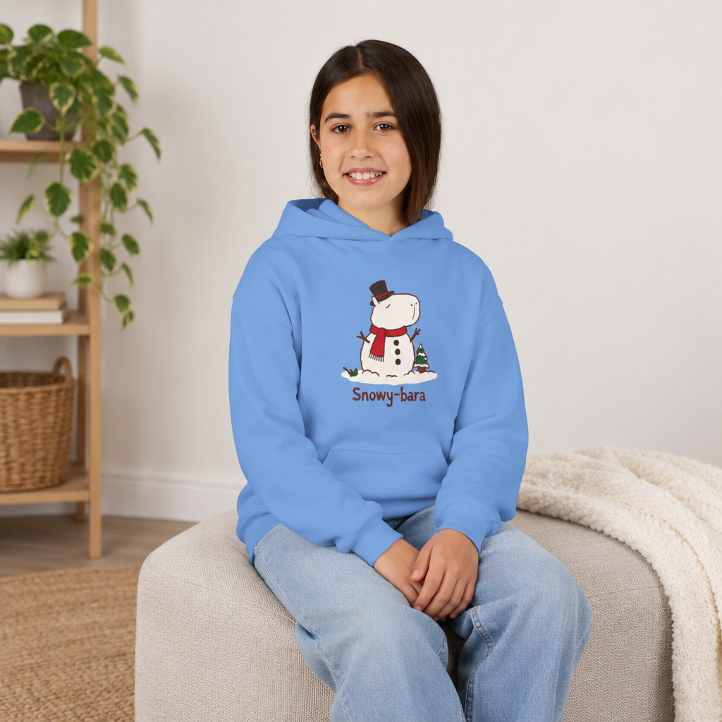 Capy Life blue youth hoodie featuring a cute Snowy-bara capybara snowman illustration worn by a smiling girl.