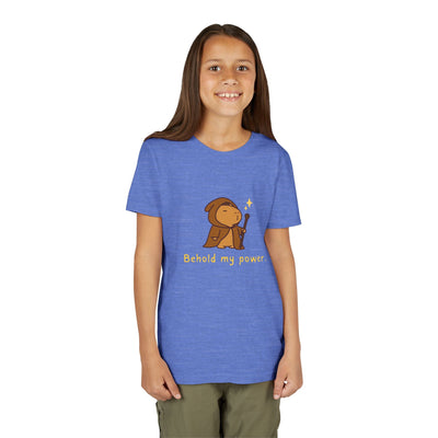 A girl wearing a blue Capy Life kids t-shirt featuring a cute wizard capybara graphic and Behold my power text.