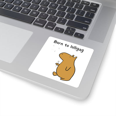 Capy Life Born to Lolligag vinyl sticker featuring a cute brown capybara holding a dandelion on a laptop