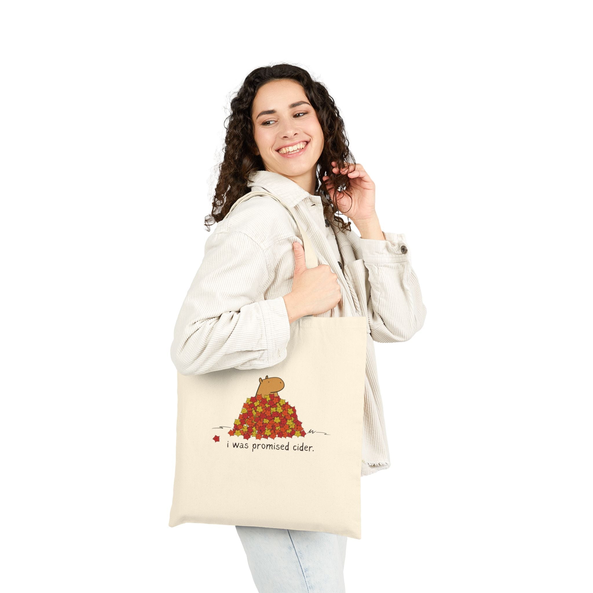 Capy Life natural canvas tote bag featuring a capybara in autumn leaves with the text I was promised cider