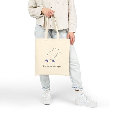 Capy Life canvas tote bag in natural cotton featuring a cute capybara on roller skates with Off to Shenan-again text.