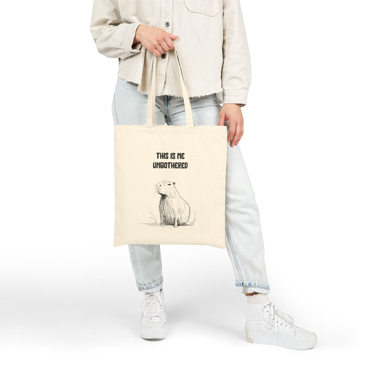 Capy Life natural cotton canvas tote bag featuring a minimalist capybara illustration and This Is Me Unbothered text.