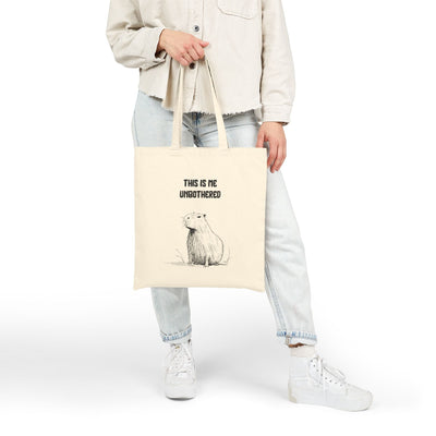 Capy Life natural cotton canvas tote bag featuring a minimalist capybara illustration and This Is Me Unbothered text.