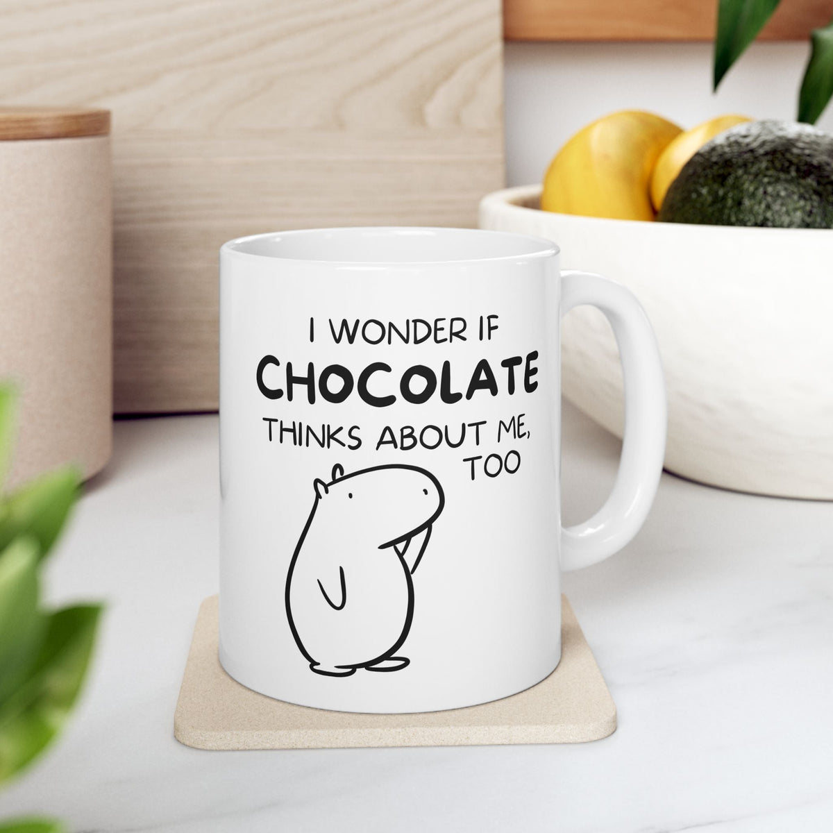Capy Life white ceramic mug featuring a hand-drawn capybara and the text I wonder if chocolate thinks about me too