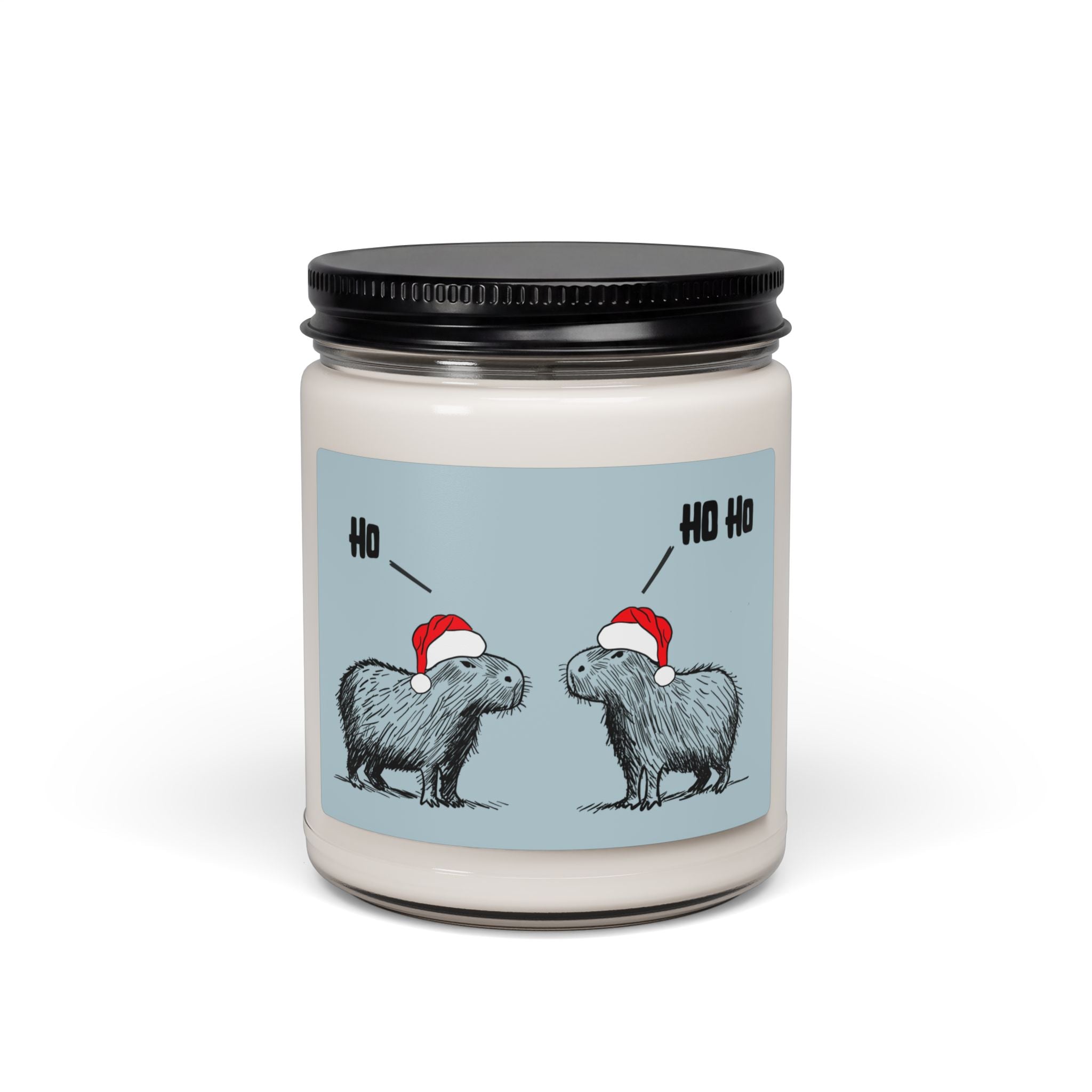 Capy Life Christmas white sage and lavender scented candle featuring two capybaras in Santa hats on a blue background with Ho Ho text