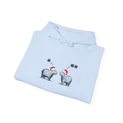 Capy Life light blue hoodie featuring two sketch-style capybaras in Santa hats saying Ho and Ho Ho for Christmas.