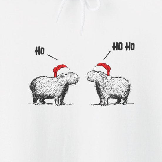 Capy Life white hoodie featuring a sketch of two capybaras in red Santa hats saying Ho and Ho Ho for Christmas
