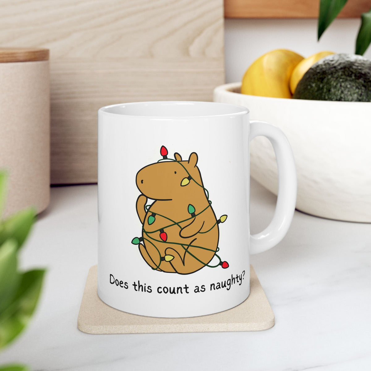 Capy Life white ceramic mug featuring a capybara tangled in colorful Christmas lights with the text Does this count as naughty?