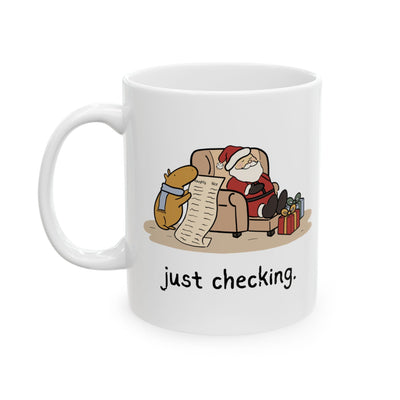Capy Life white ceramic mug featuring a capybara in a blue scarf checking Santa's naughty or nice list while he naps.