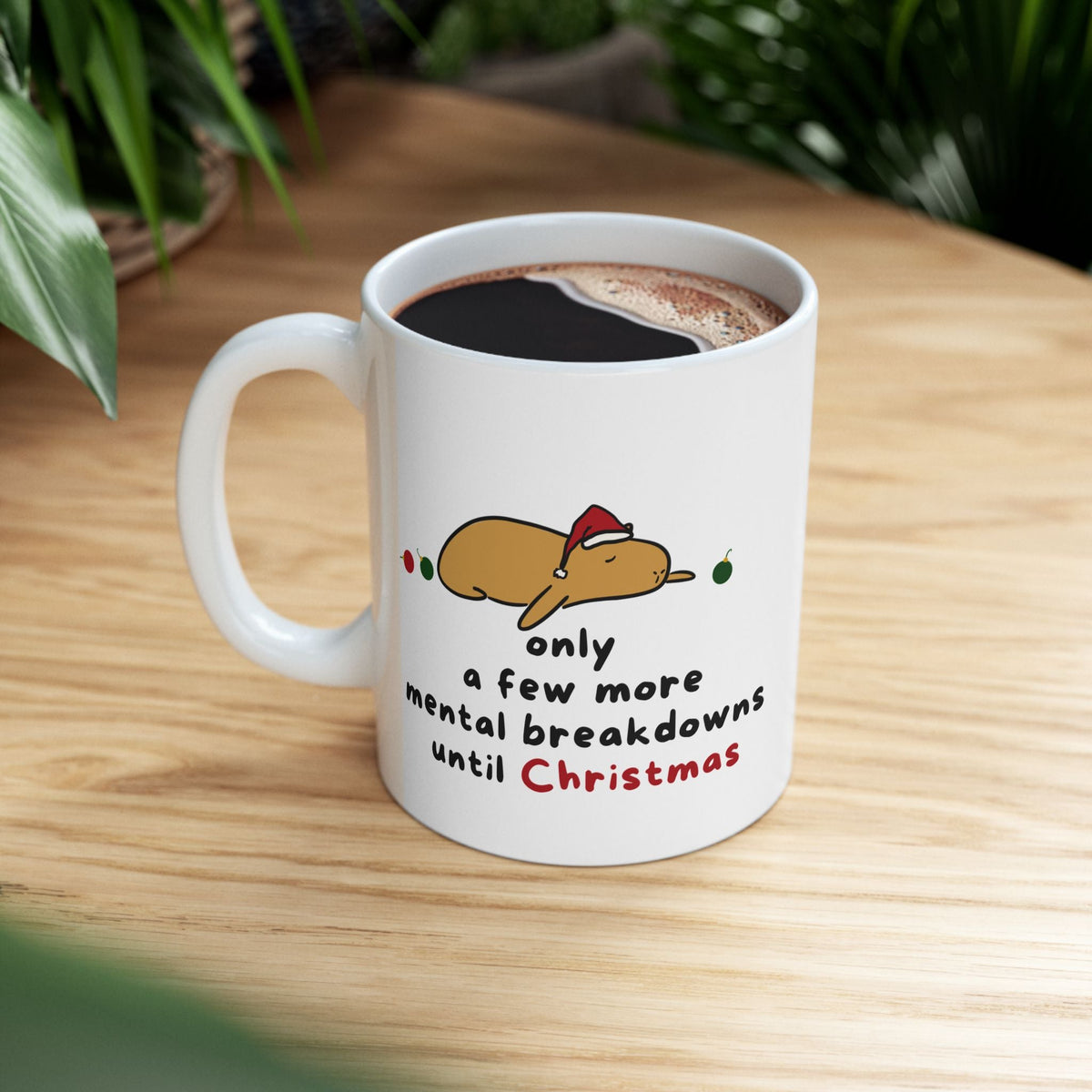 Capy Life white ceramic mug featuring a cartoon capybara in a Santa hat with the text Only a few more mental breakdowns until Christmas.