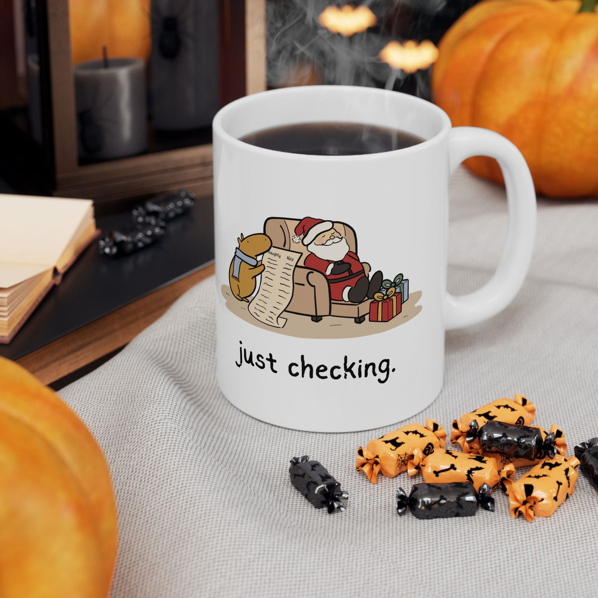 Capy Life white ceramic mug featuring a capybara in a blue scarf checking Santa's naughty or nice list.
