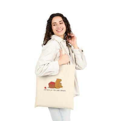 Capy Life natural canvas tote bag featuring a cute capybara with apples and the text I am here for the cider donuts