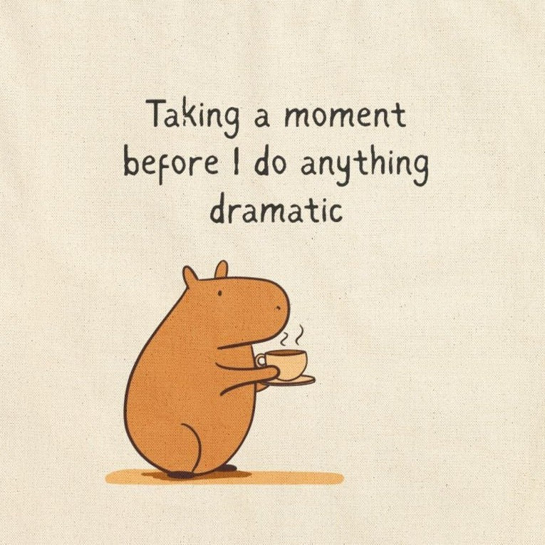 Capy Life canvas tote bag featuring a cute capybara drinking coffee with the text Taking a moment before I do anything dramatic