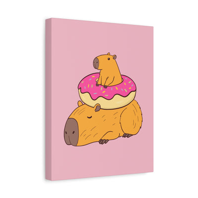 Capy Life canvas wall art featuring a relaxed capybara with a smaller capybara sitting in a pink frosted donut.