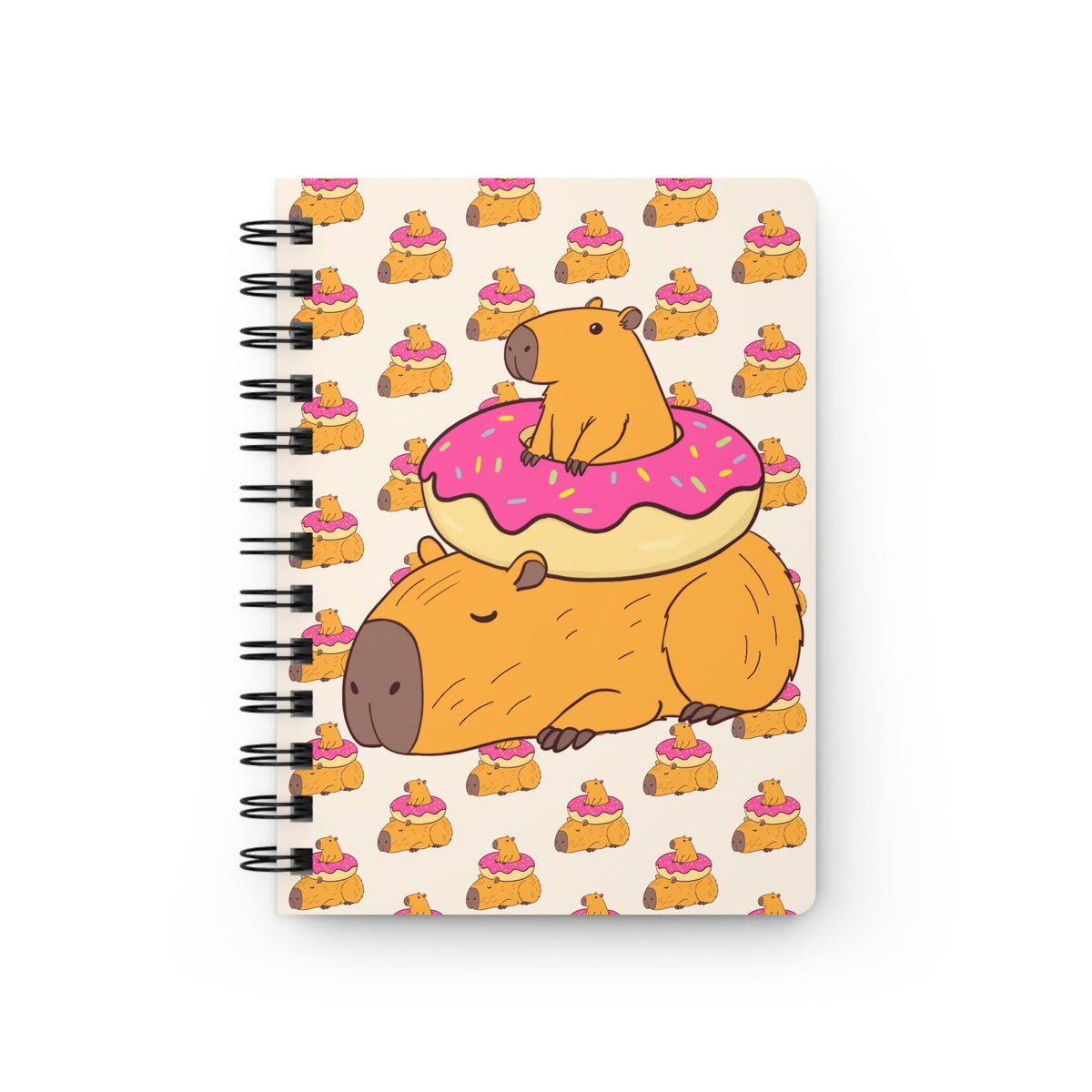 Capy Life spiral-bound notebook featuring a pattern of capybaras lounging on pink frosted donuts on a cream background.