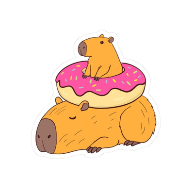 Capy Life sticker featuring two cute capybaras, one napping and one sitting inside a pink frosted donut with sprinkles.