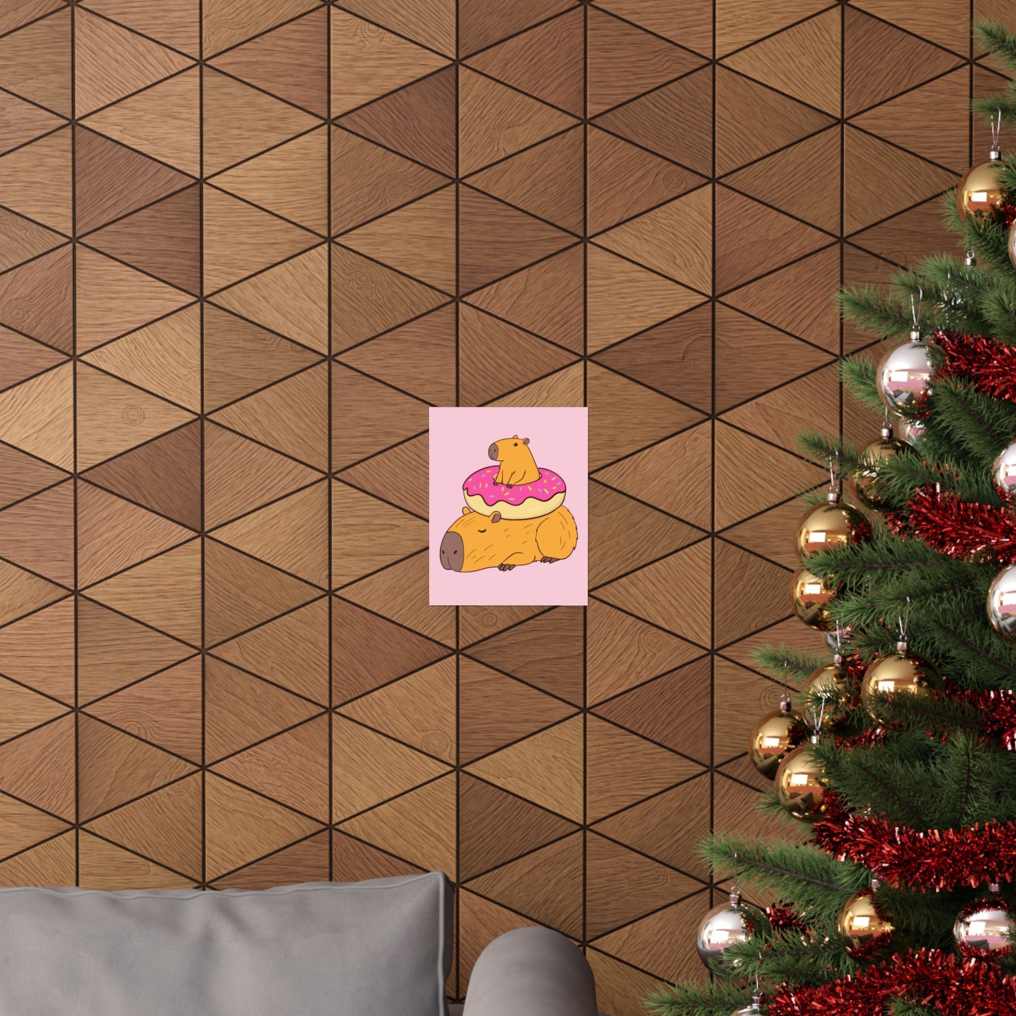 Capy Life wall art print featuring a cute capybara with a donut on a soft pink background, displayed on a wood wall.