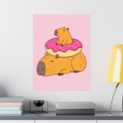Capy Life wall art print featuring a cute capybara sitting on a frosted donut atop another sleeping capybara.