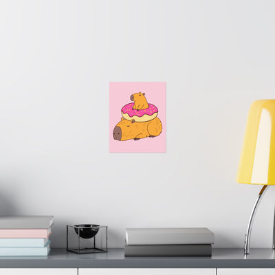 Capy Life wall art print featuring a cute capybara with a donut on a soft pink background in a nursery setting.