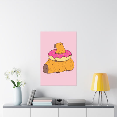 Capy Life wall art print featuring a cute capybara with a donut on its back, set against a soft pink background.