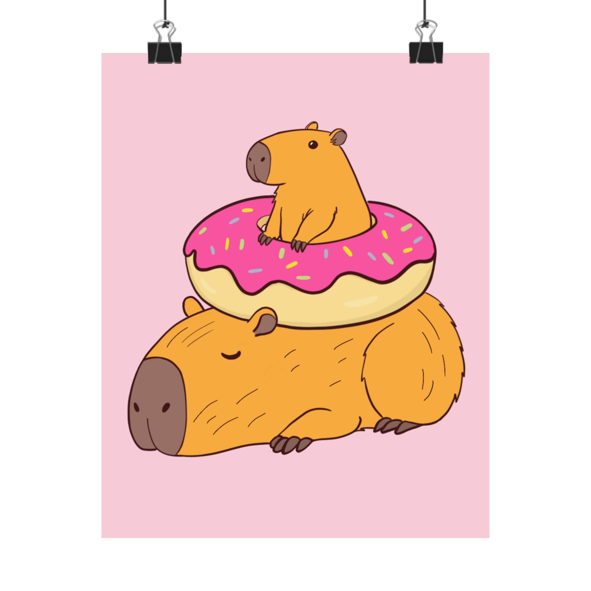 Capy Life wall art print featuring a cute capybara sitting on a frosted donut atop a sleeping capybara, pink background.