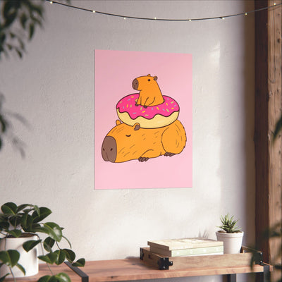 Capy Life wall art print featuring a cute capybara with a donut on a soft pink background in a cozy nursery setting.