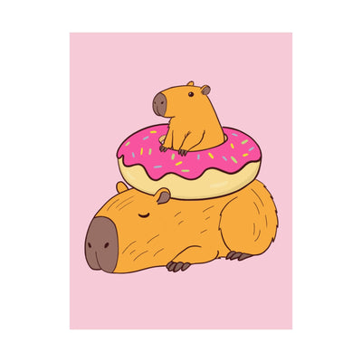 Capy Life wall art print featuring a cute capybara lounging under a frosted donut on a soft pink background.