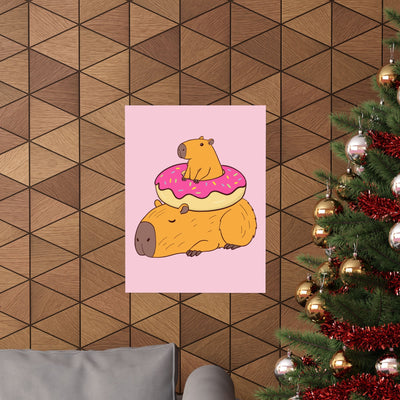 Capy Life wall art print featuring a cute capybara with a donut on a soft pink background, displayed in a festive room.