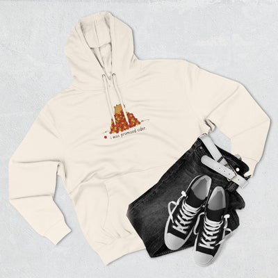 Capy Life cream fleece hoodie featuring a capybara in autumn leaves with the text I was promised cider, flat lay.