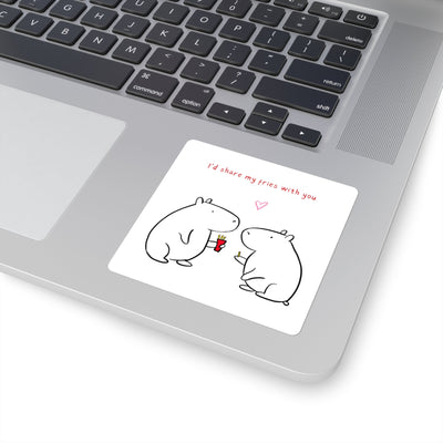 Capy Life square vinyl sticker featuring two cute capybaras sharing fries, applied to a silver laptop surface.