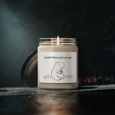 Capy Life soy wax candle in a glass jar featuring a cute Gene the Capybara illustration holding flowers.