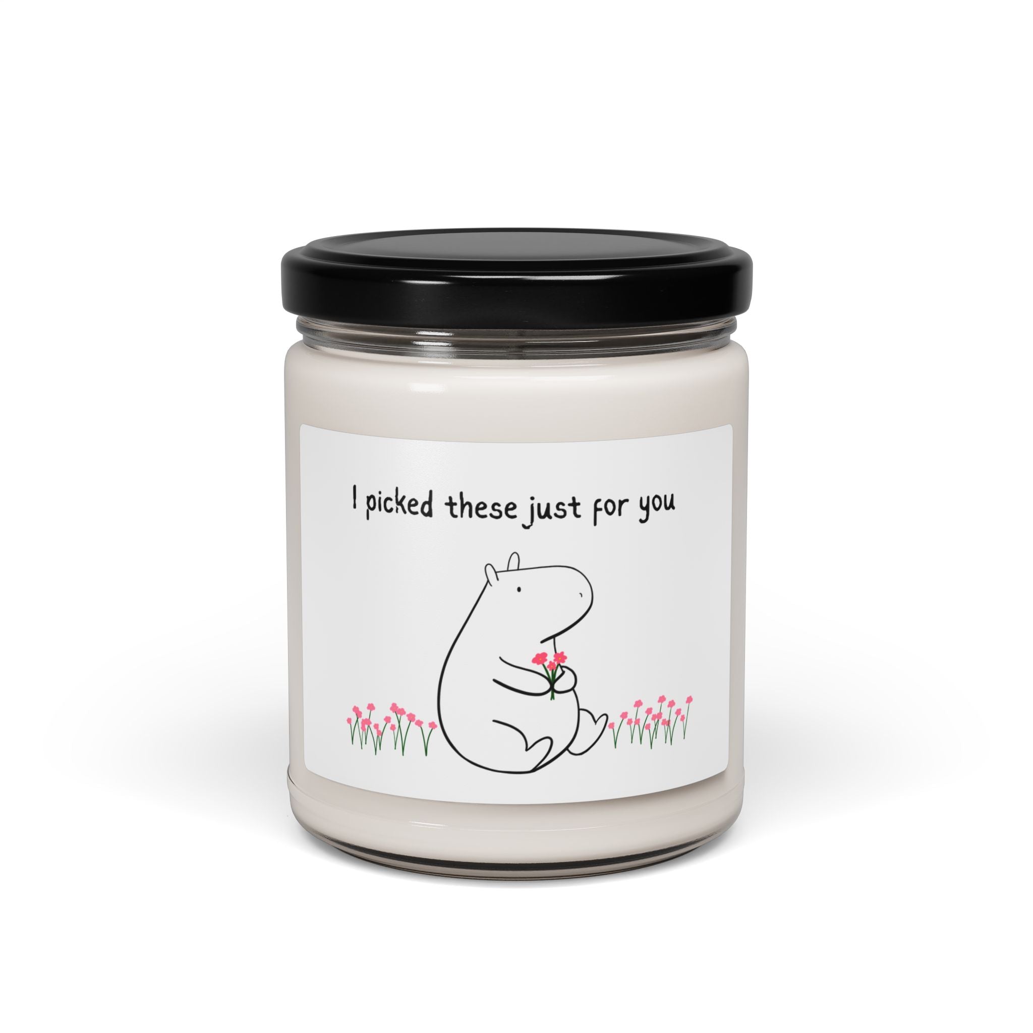 Capy Life clean cotton scent soy wax candle in a glass jar with a cute capybara illustration holding flowers and a thoughtful message.