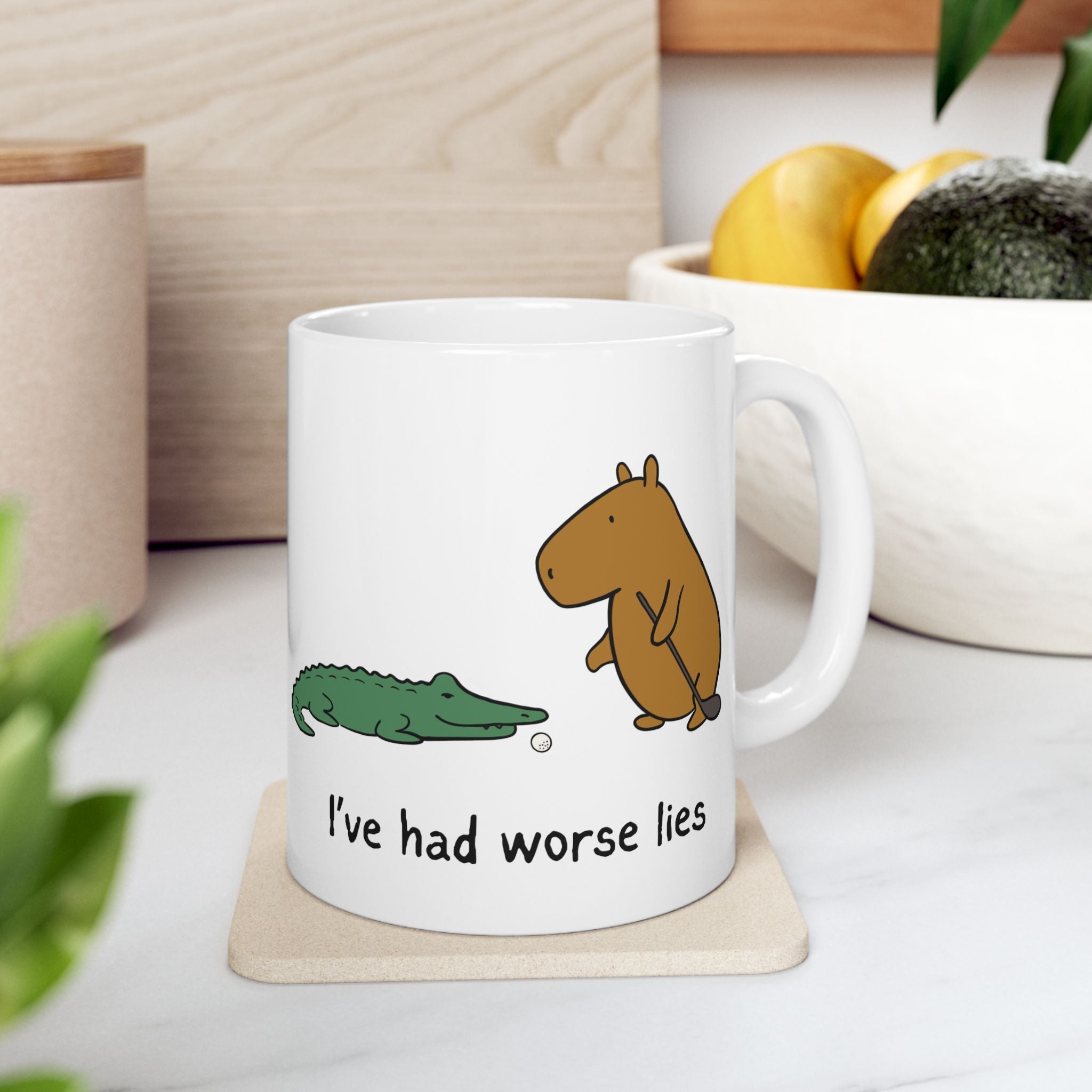 Capy Life white ceramic coffee mug featuring a capybara and alligator with the text I've had worse lies