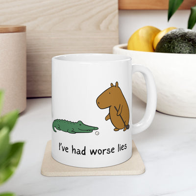 Capy Life white ceramic coffee mug featuring a capybara and alligator with the text I've had worse lies
