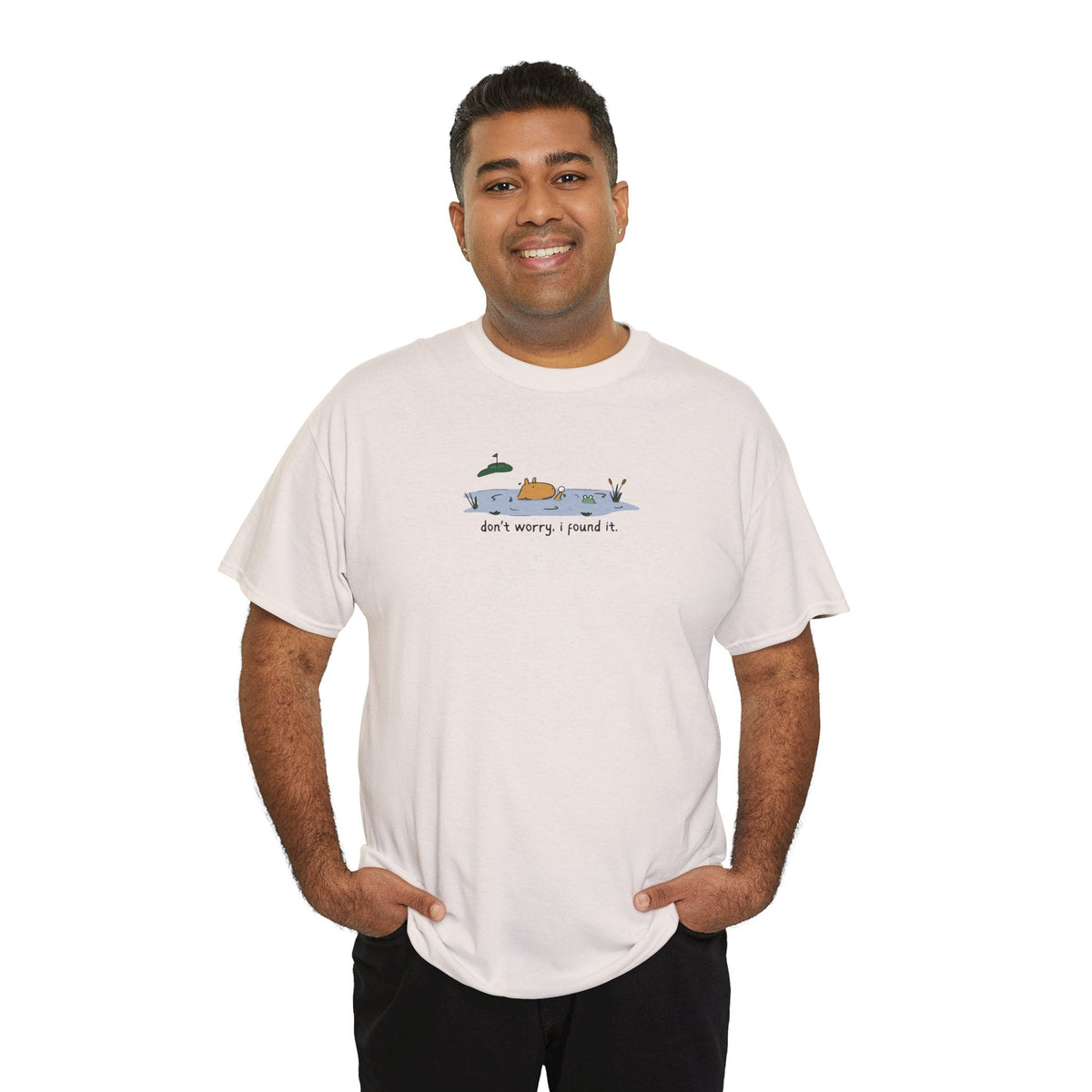 Man wearing a white Capy Life heavy cotton t-shirt with a funny capybara golf illustration on the chest.