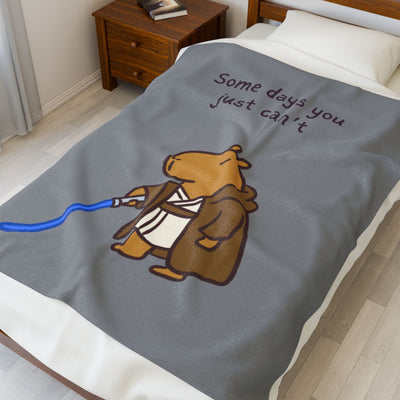 Capy Life velveteen plush blanket featuring a capybara Jedi with a lightsaber and the text Some days you just can't.