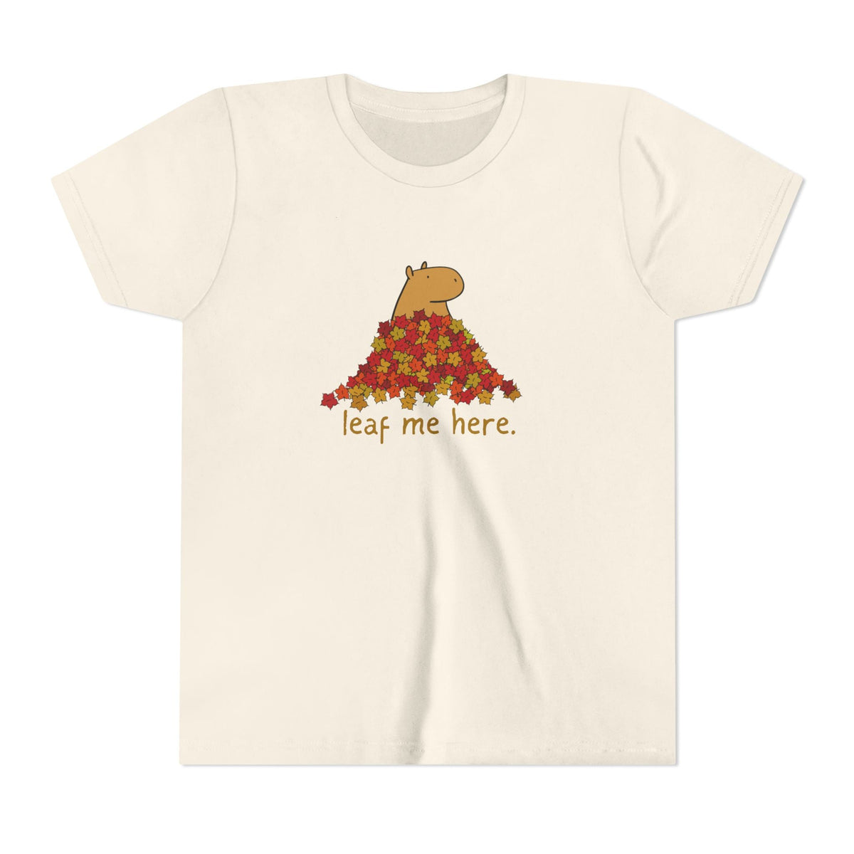 Capy Life youth t-shirt in cream featuring a capybara in a pile of autumn leaves with the text leaf me here