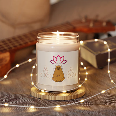 Capy Life meditation candle in a glass jar with a meditating capybara and lotus label, surrounded by fairy lights.